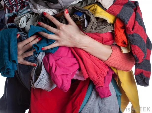 womans-arms-full-of-clothes